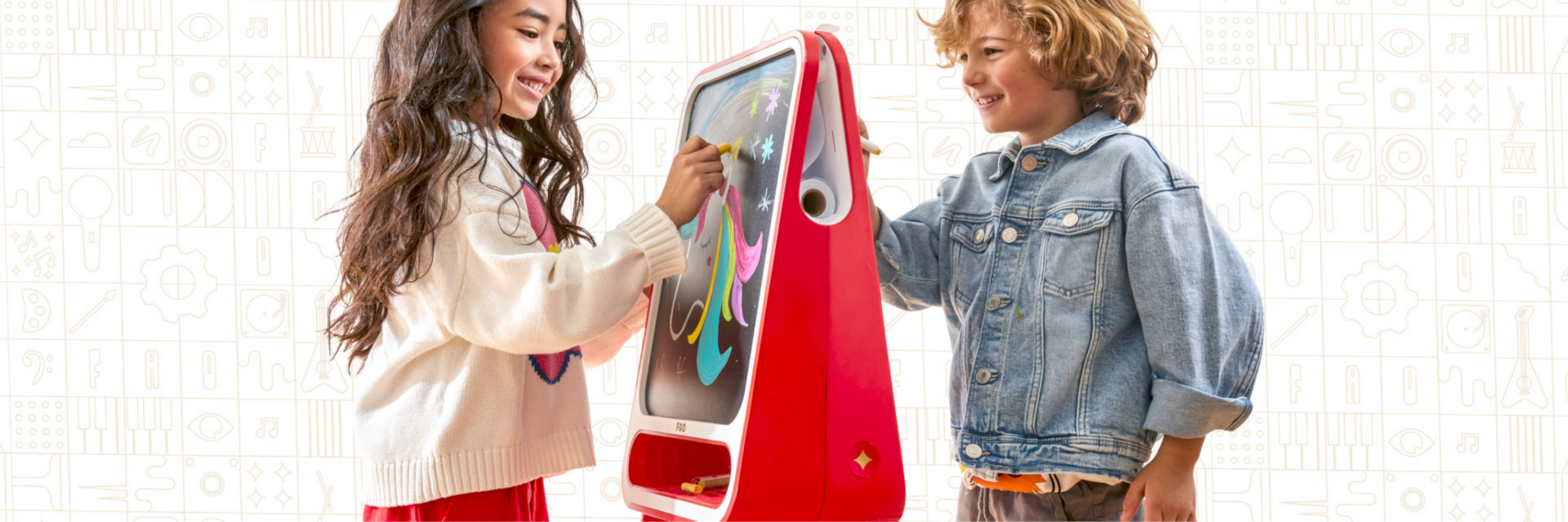 Two children interacting with a red and gray electronic device on a white background