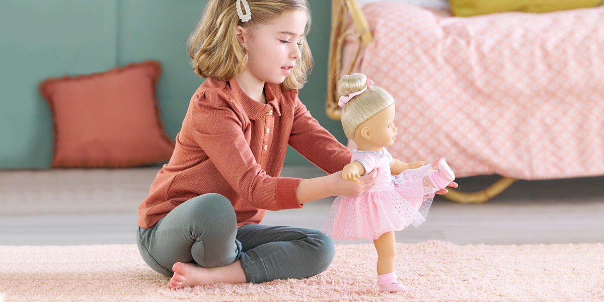 Child playing with a doll on a carpeted floor