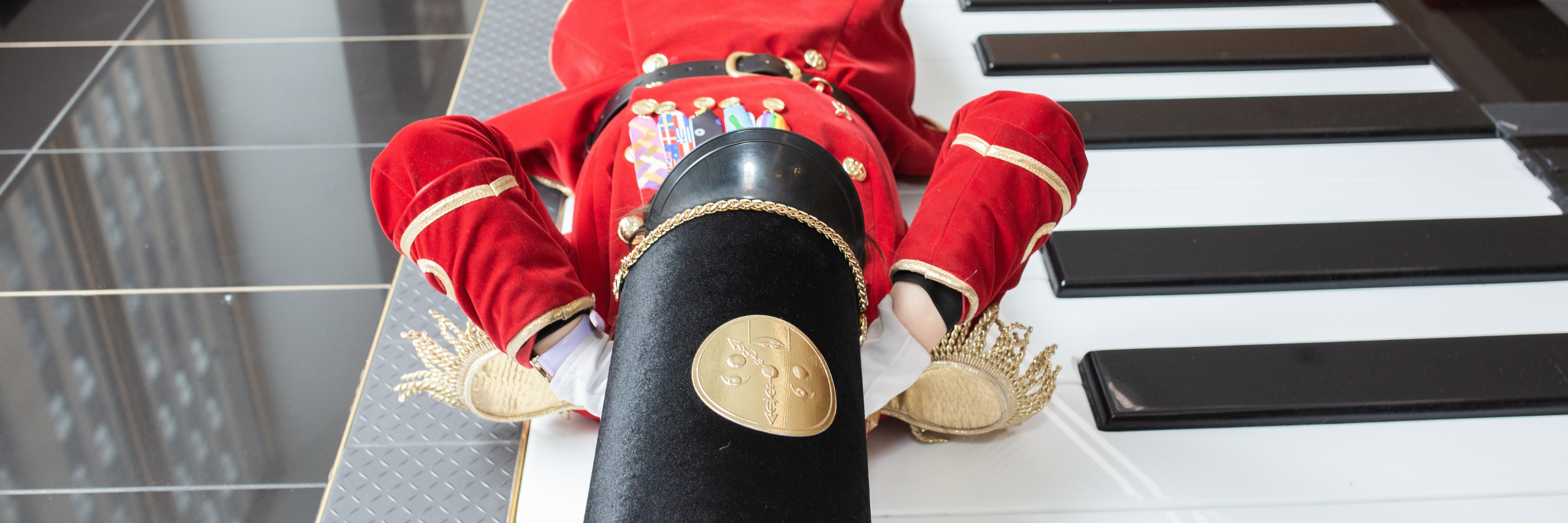 Red toy soldier on a piano keyboard