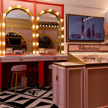 Vintage-style beauty salon with mirrors and a television screen.