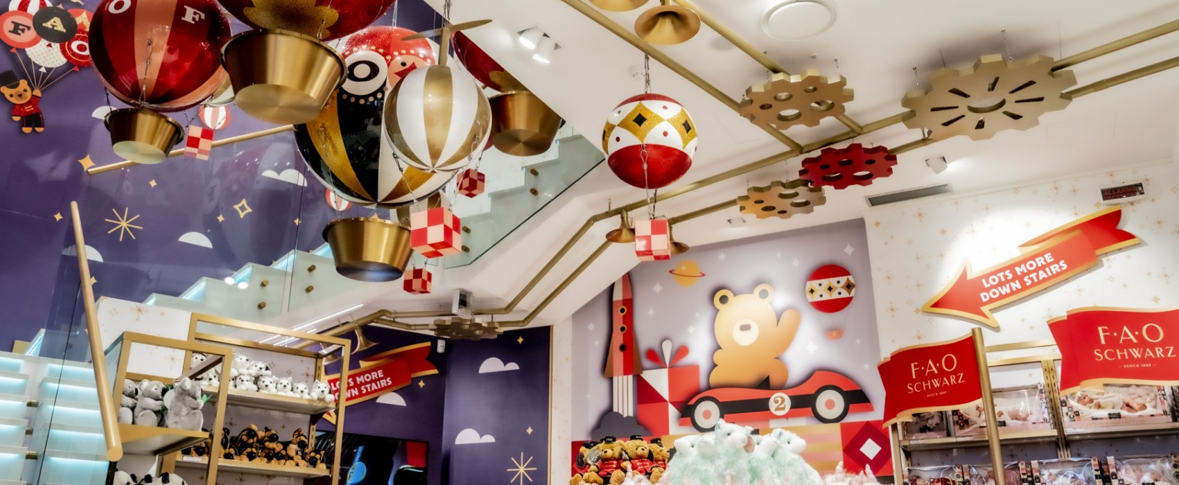 Decorative ceiling with colorful balloons and signs in a store setting