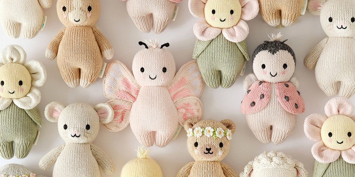 Collection of soft toy figures with various designs on a light background