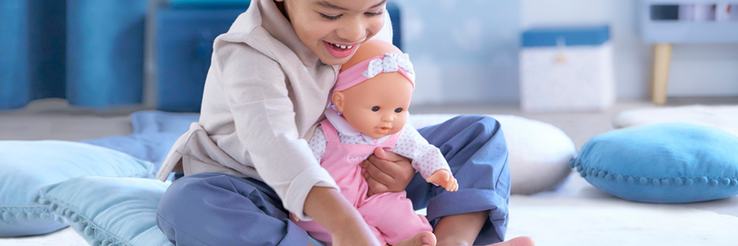 Child playing with a doll on a couch in a living room setting