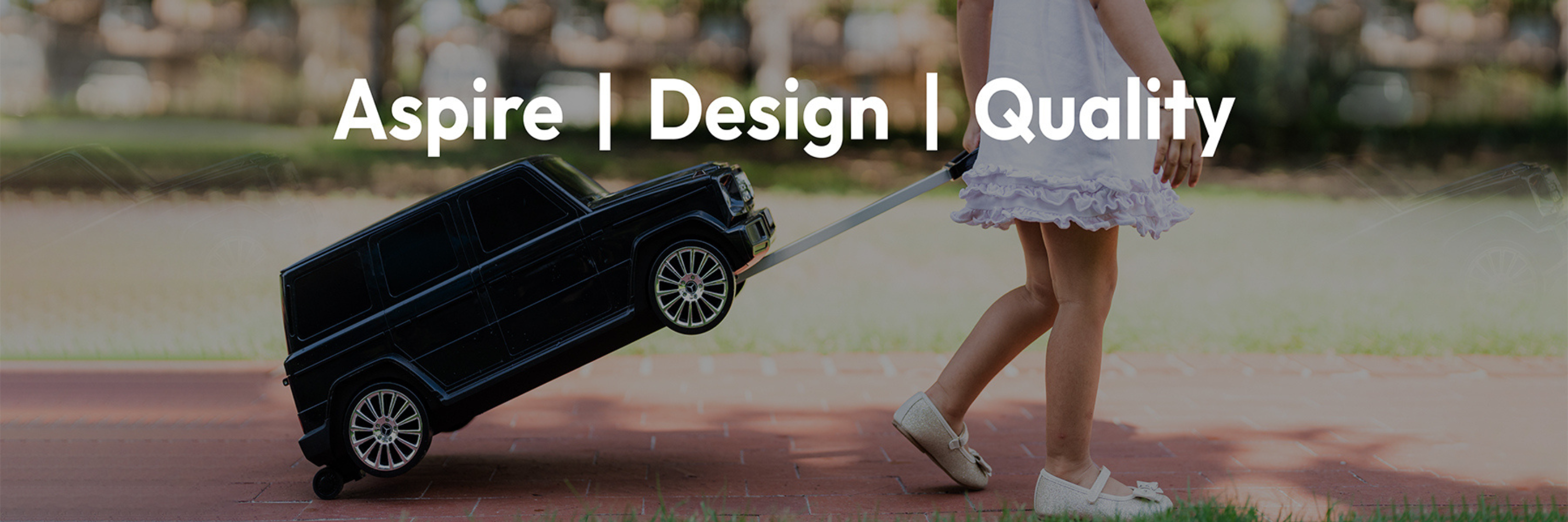 Child pulling a toy car with 'Aspire | Design | Quality' text overlay.