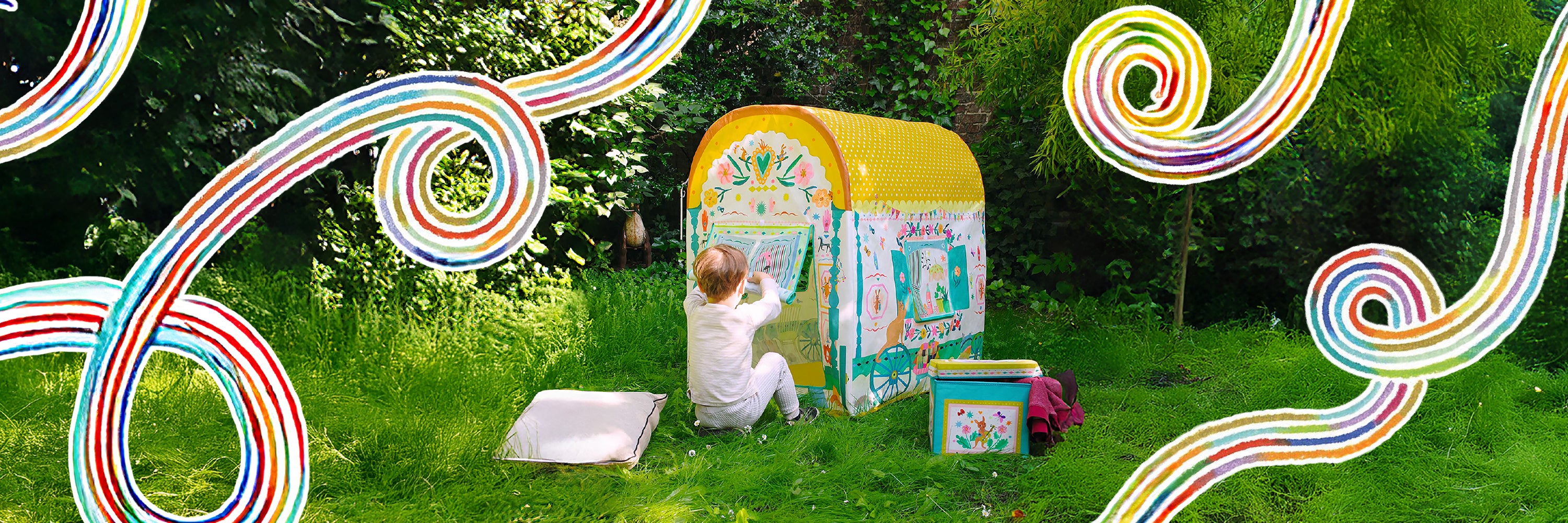 Child playing with a colorful play tent in a grassy area with decorative swirls.
