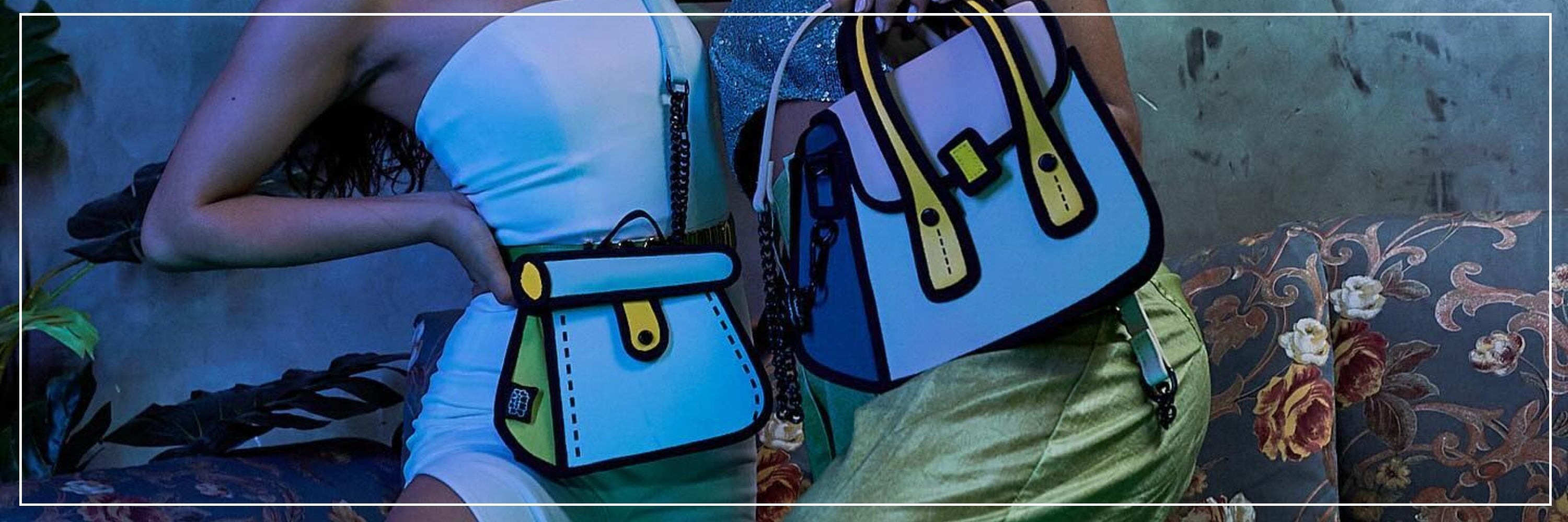 Two people holding colorful handbags on a patterned rug.