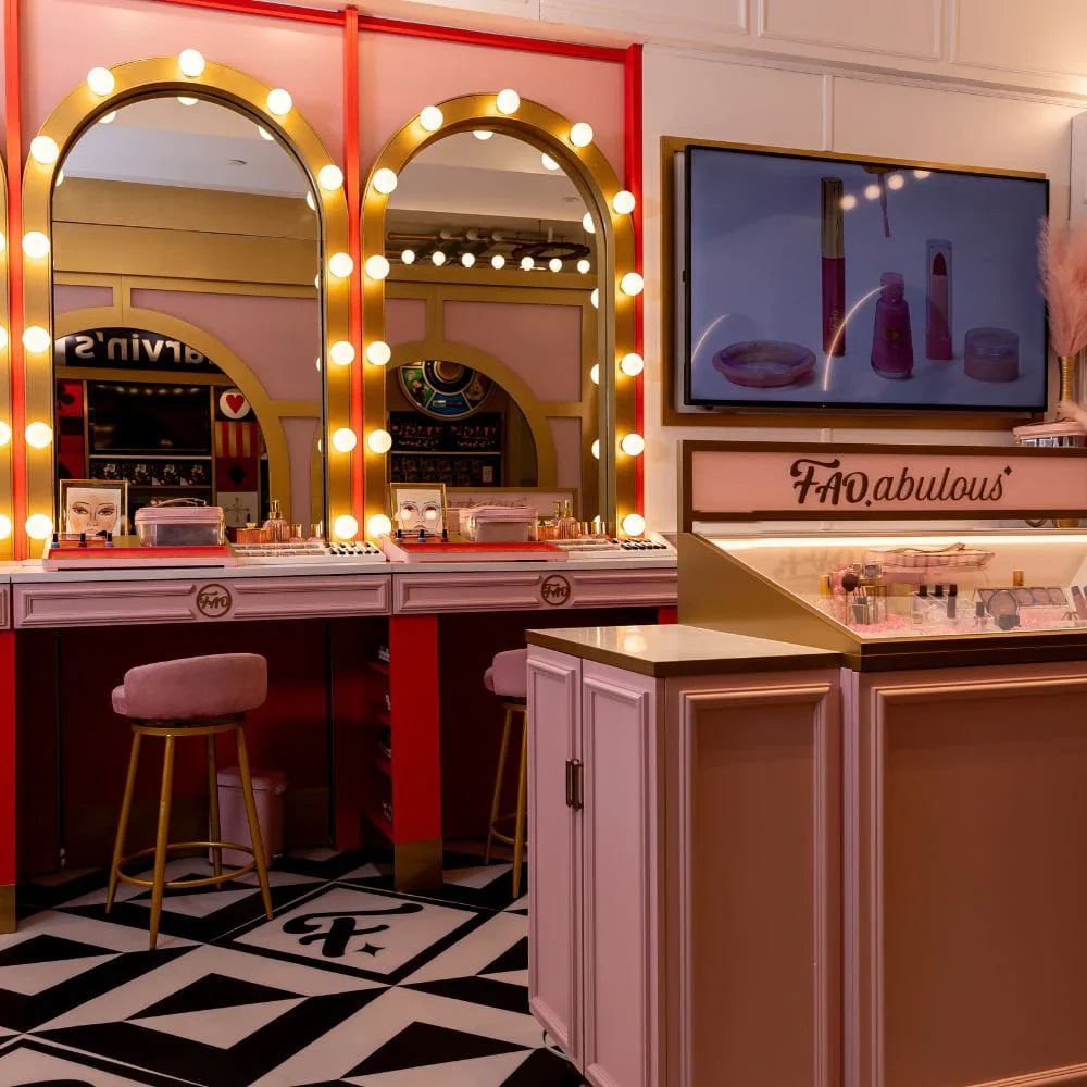 Decorative makeup station with heart-shaped mirrors and a TV screen displaying products.
