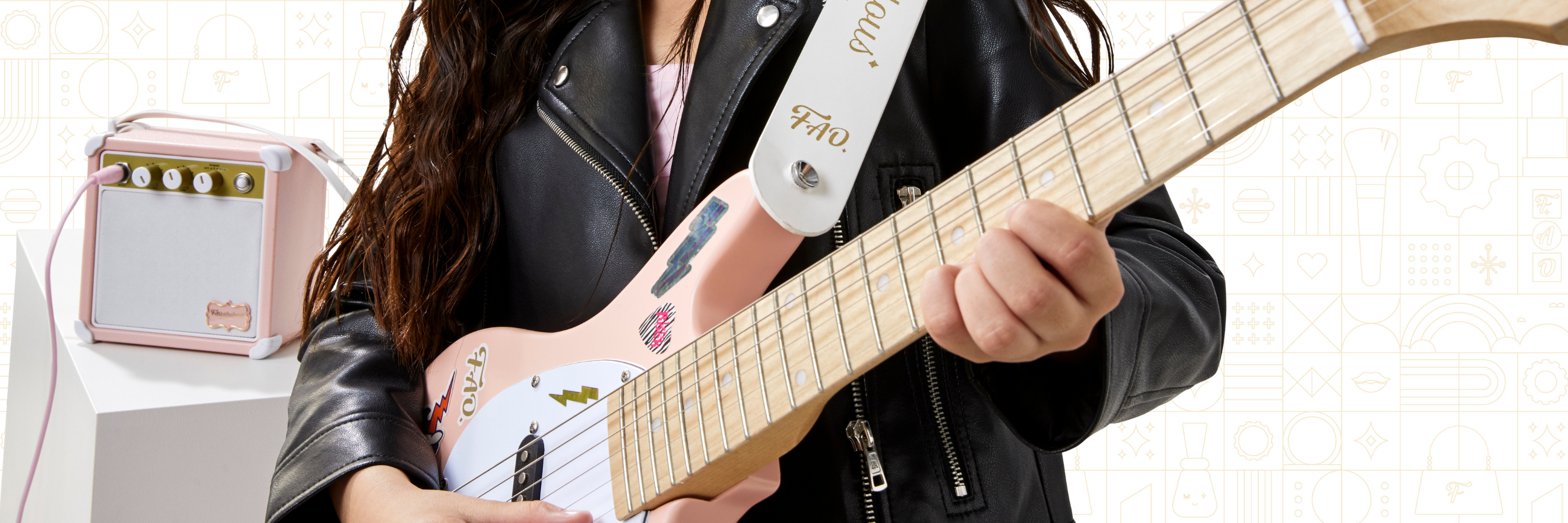 Person playing a white electric guitar with a small amplifier in the background