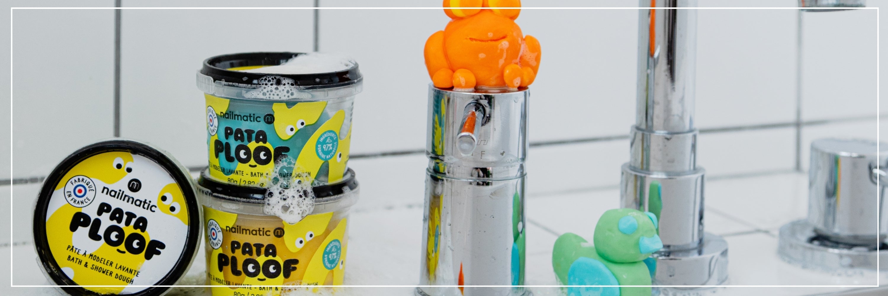 Bathroom setting with Pata Floof products and bath toys on a tiled wall.