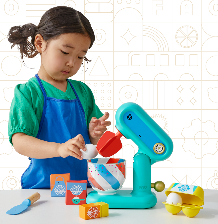 Child playing with a toy kitchen set against a geometric-patterned wall.