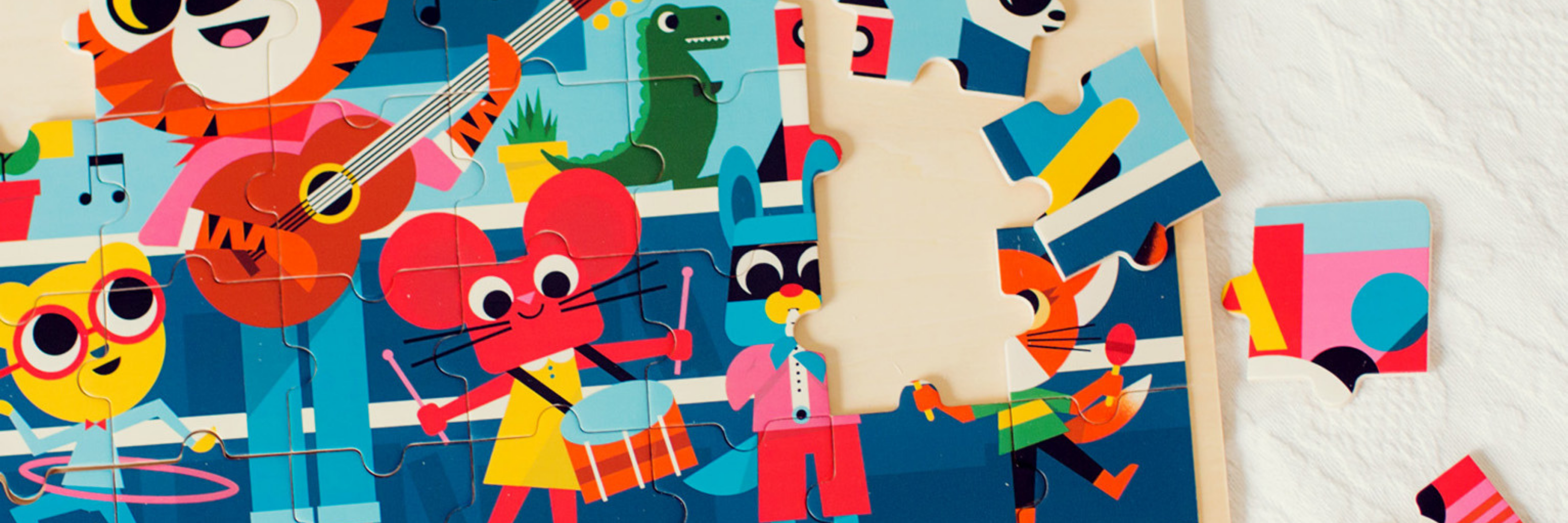 Colorful children's puzzle with cartoon characters on a wooden board.