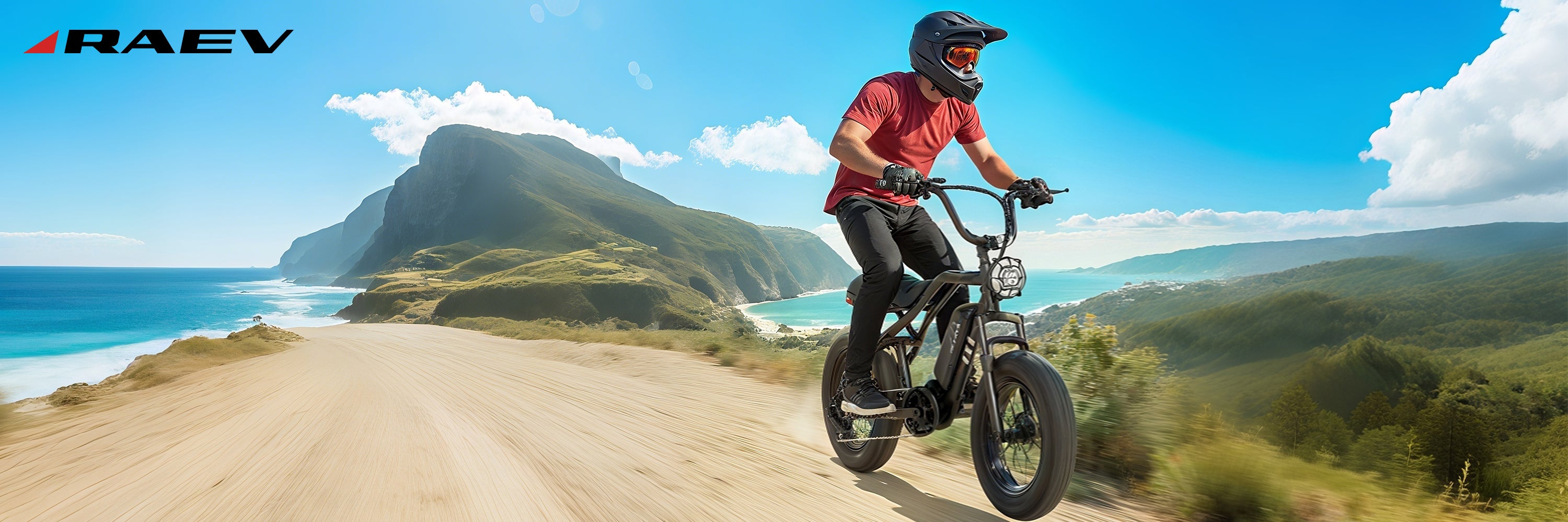 Person riding a bike on a scenic coastal road with mountains in the background