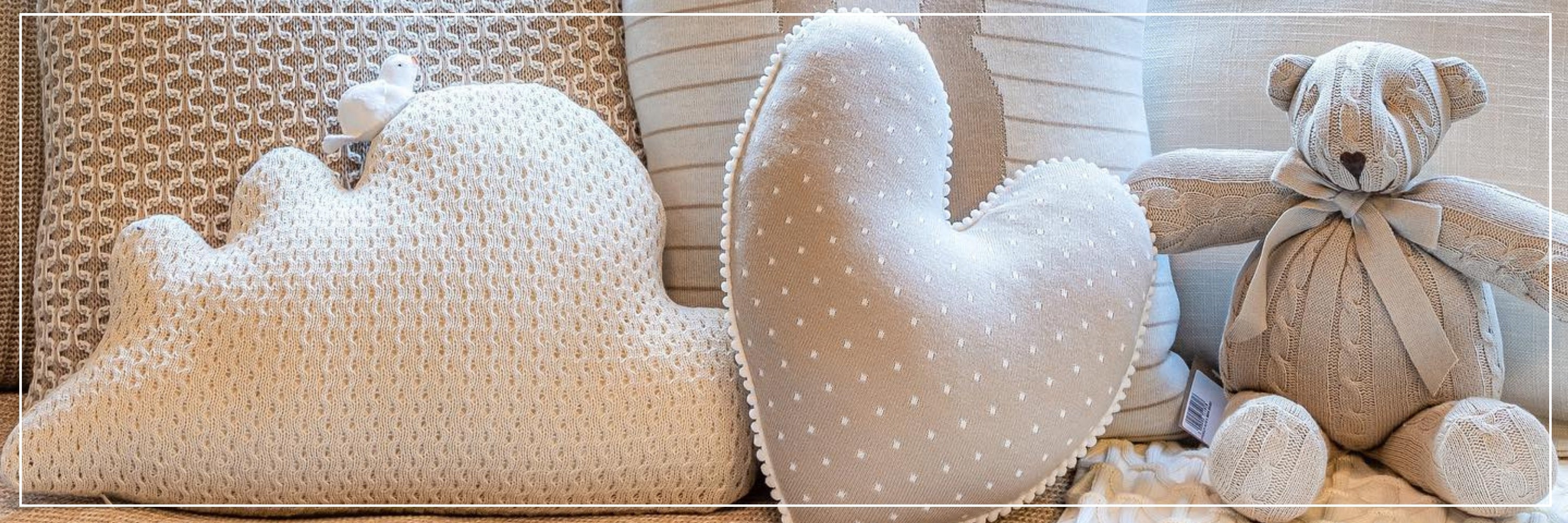 Heart-shaped pillow with a teddy bear on a textured surface