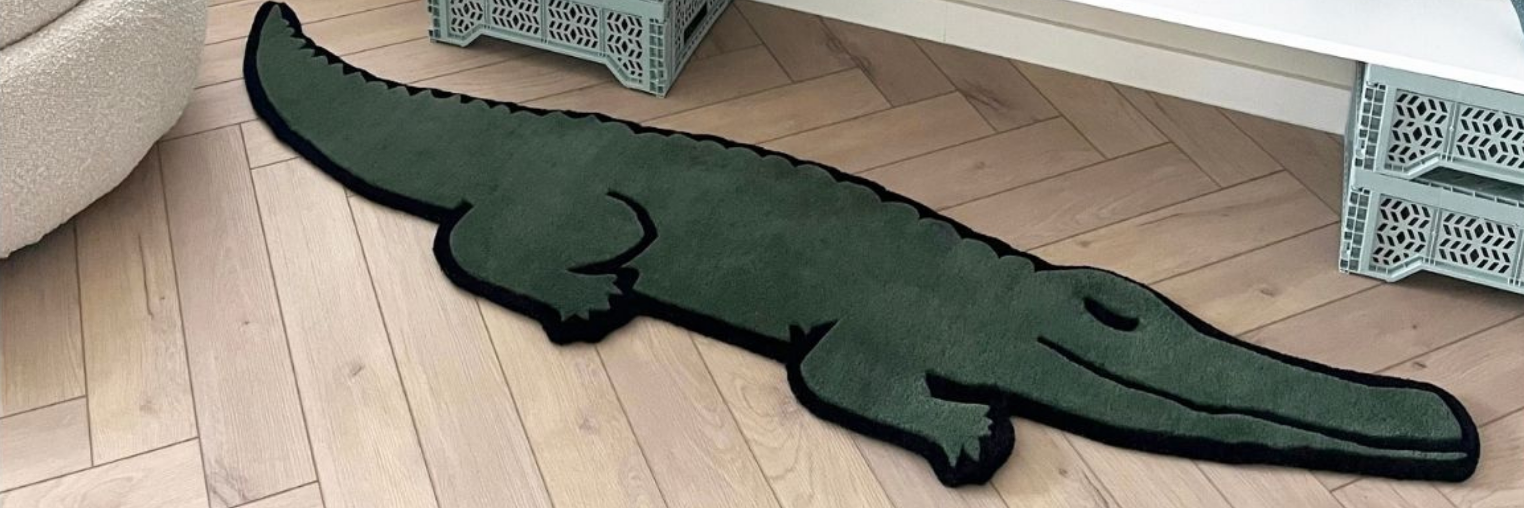 Green alligator-shaped rug on a wooden floor