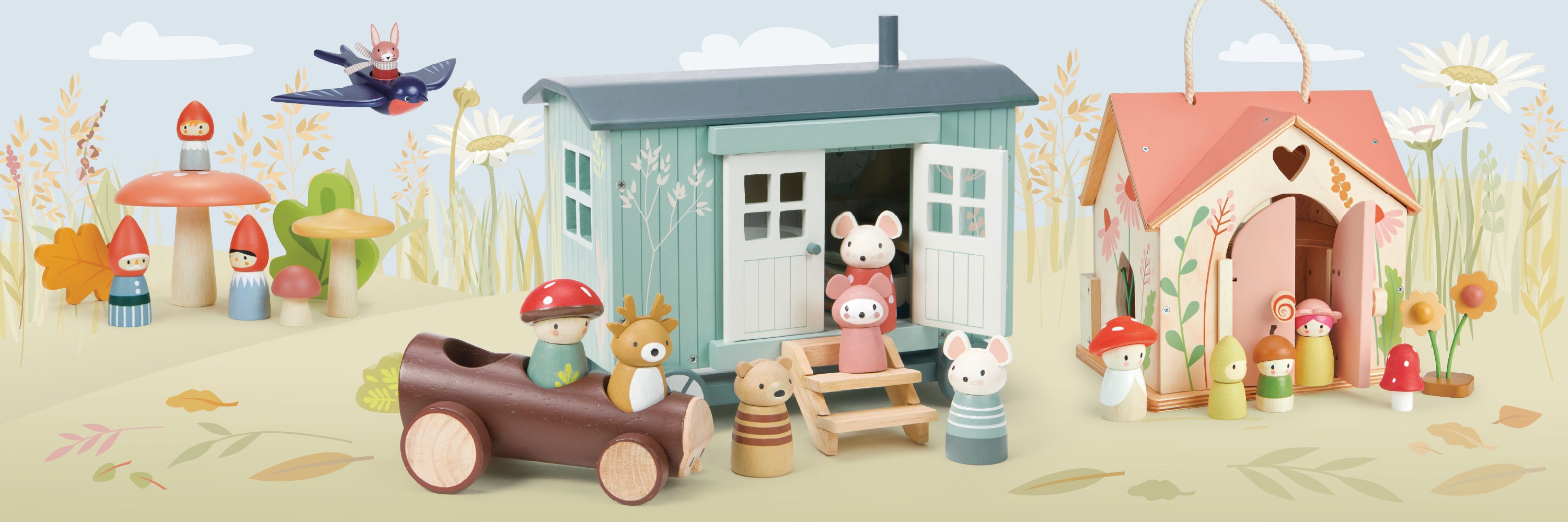 Toy houses and animals on a sandy beach with a clear sky