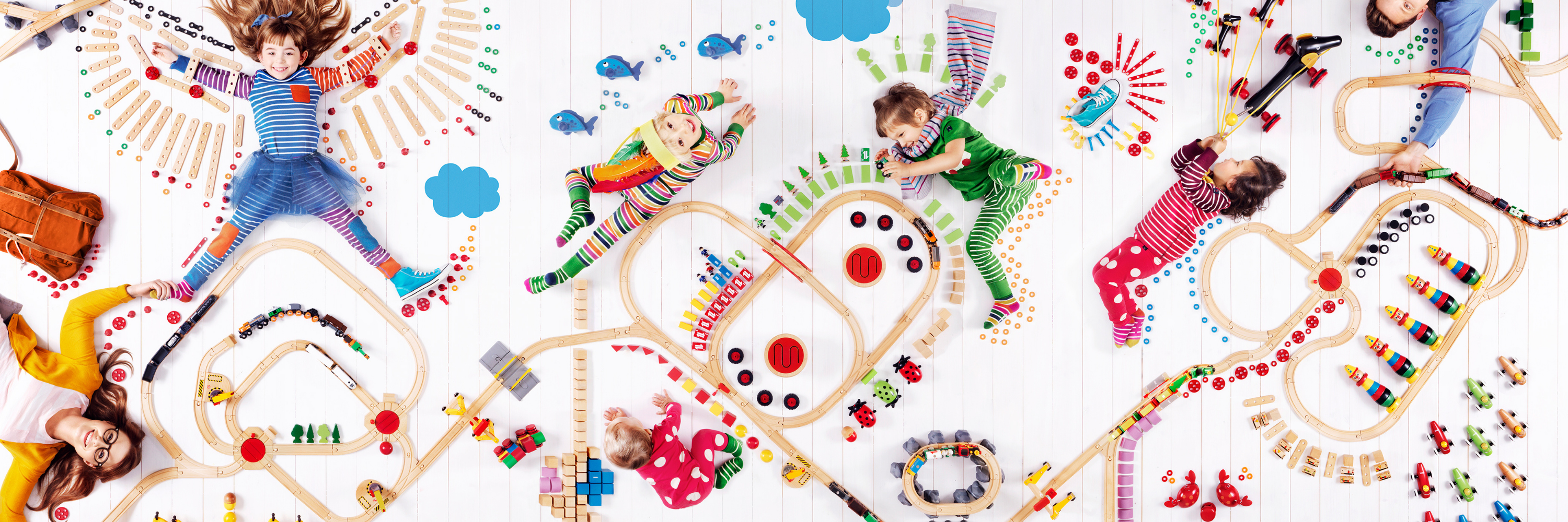 Children playing with toys on a colorful floor pattern
