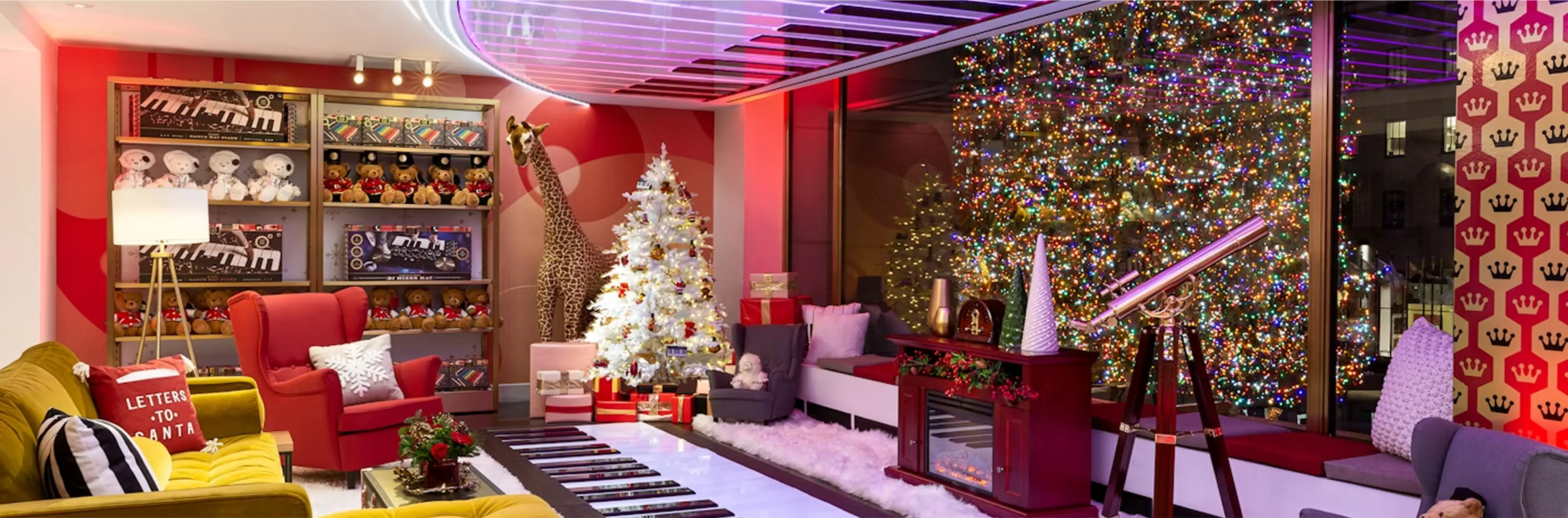 Modern living room with Christmas decorations, including a tree and colorful walls.