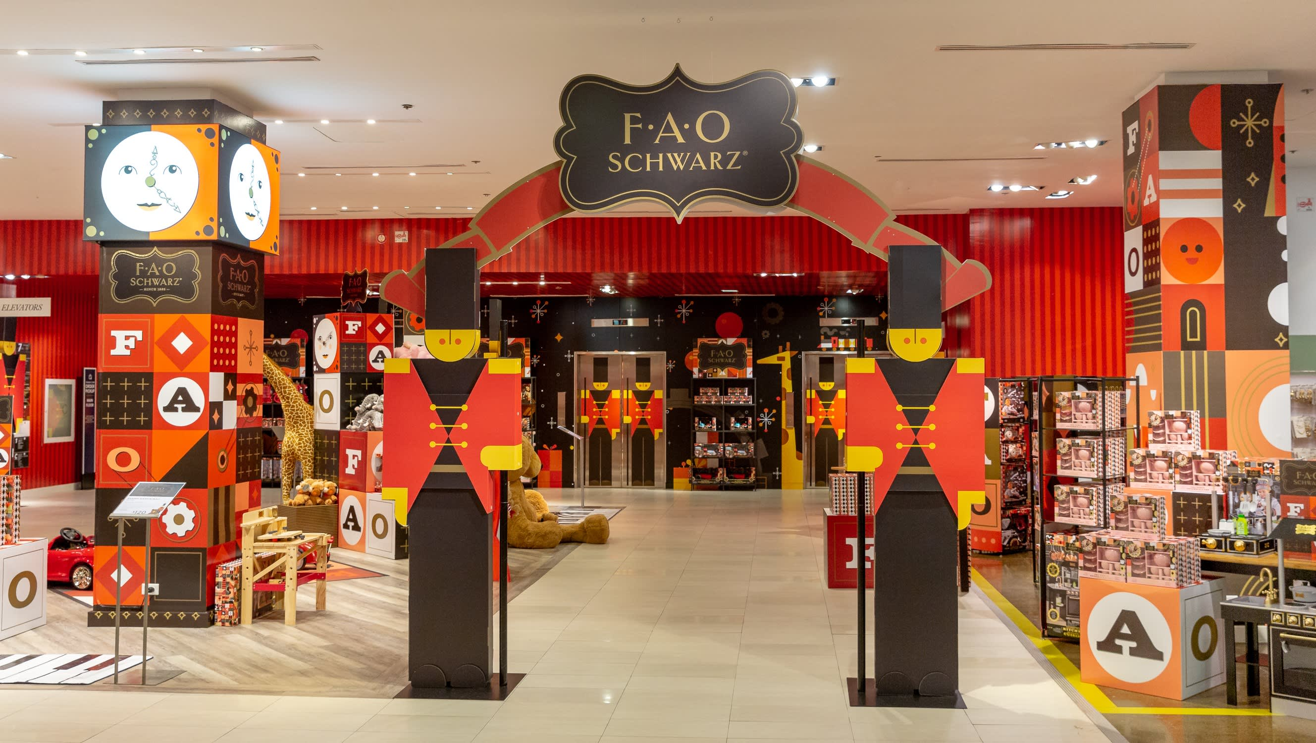 F.A.O. Schwarz store entrance with colorful geometric designs and store name signage.