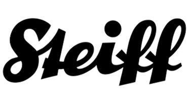 Stuffed animal with a red bow tie and plaid jacket on a white background