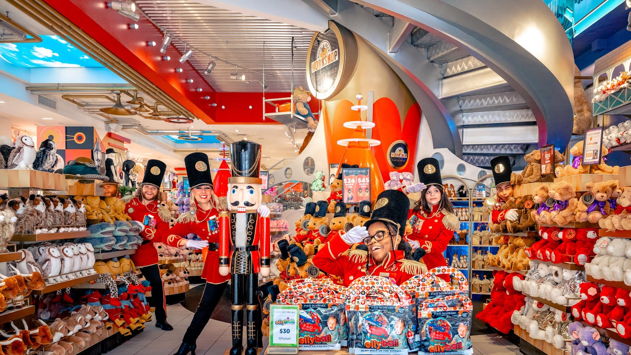People dressed as toy soldiers in FAO Schwarz toy store with teddybears and stuffed animals around.